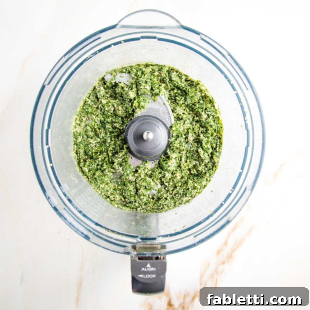 Vibrant Carrot Top Pesto 8 Food processor bowl filled with bright green pesto.