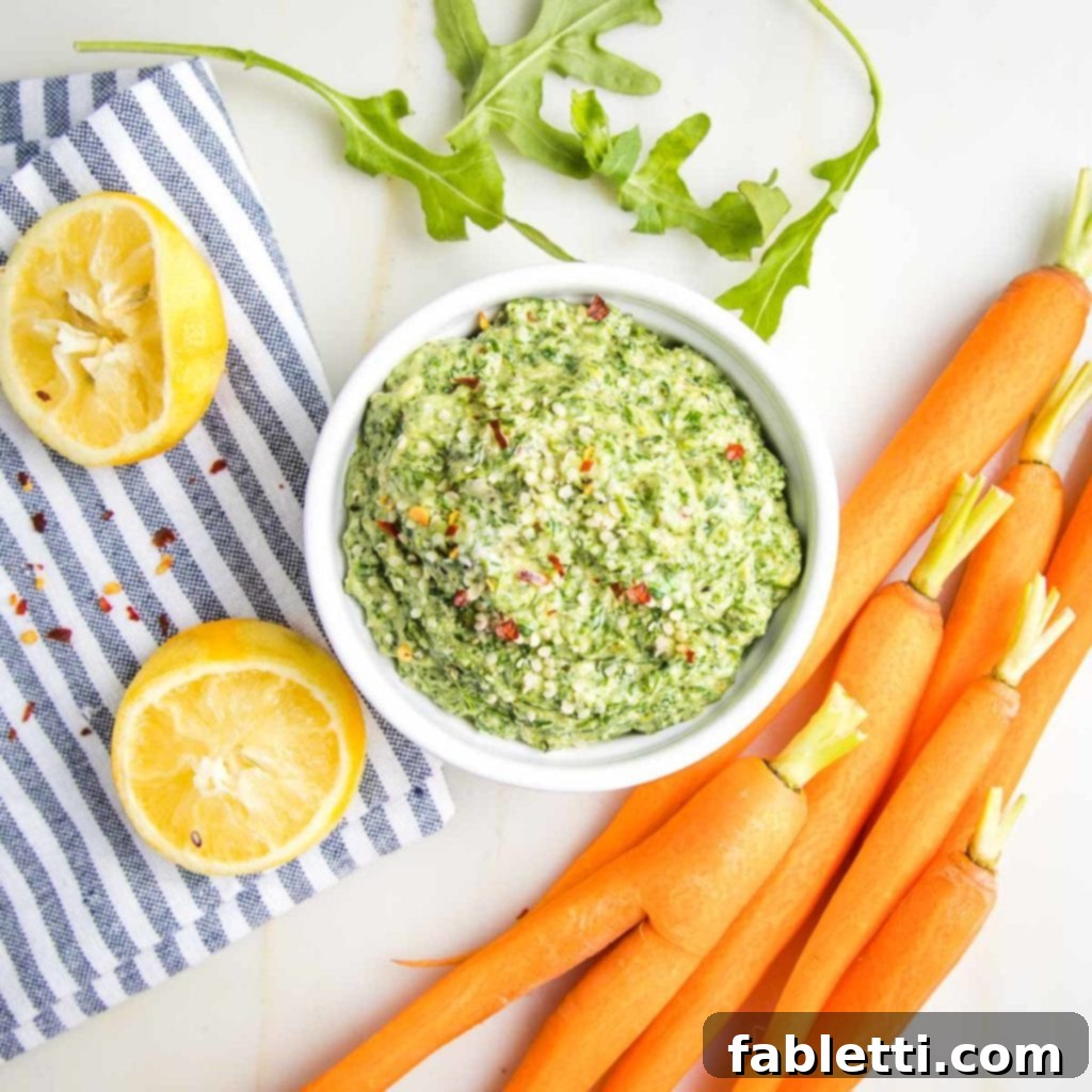 Vibrant Carrot Top Pesto 10 Carrots, lemons, arugula around a bowl of pesto.