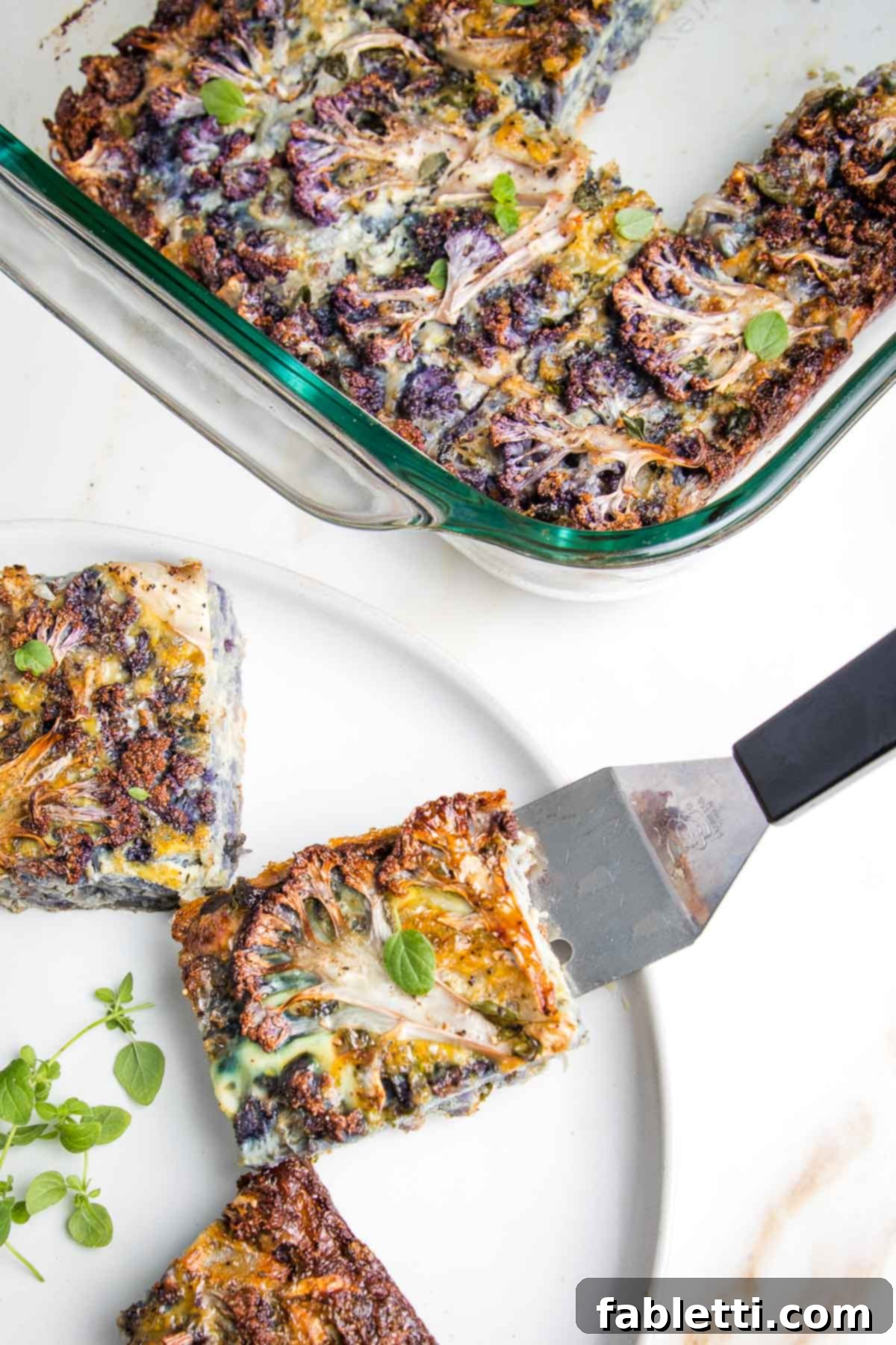 Cauliflower kugel in a baking dish and with spatula on plate, ready to be served.