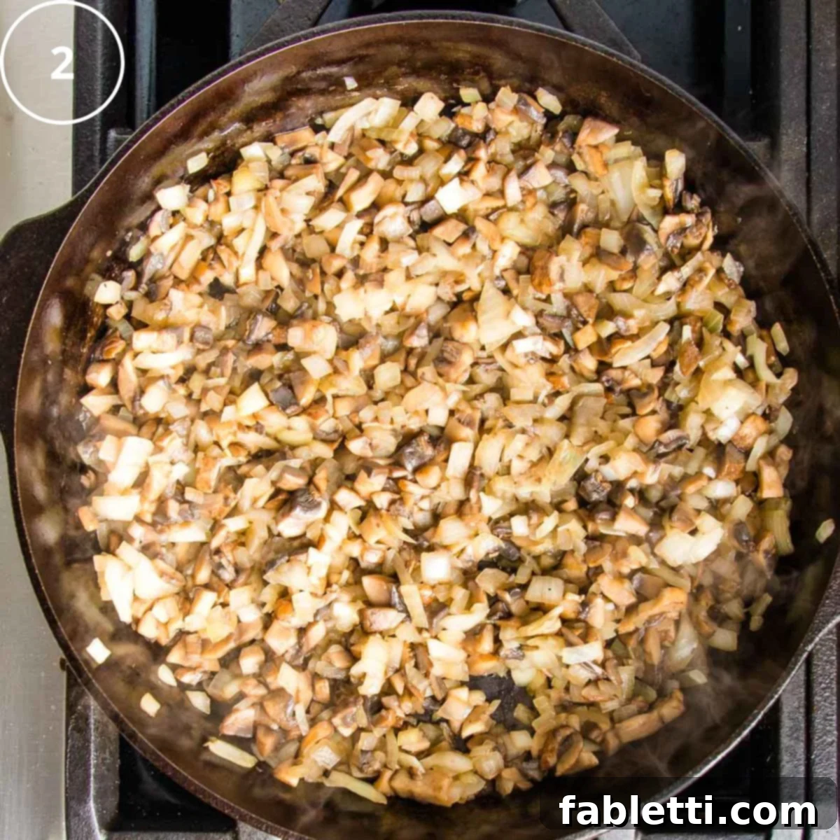 Sun-Kissed Vegan Shepherd's Pie 12 Sauteed onions and mushrooms in a cast iron skillet.