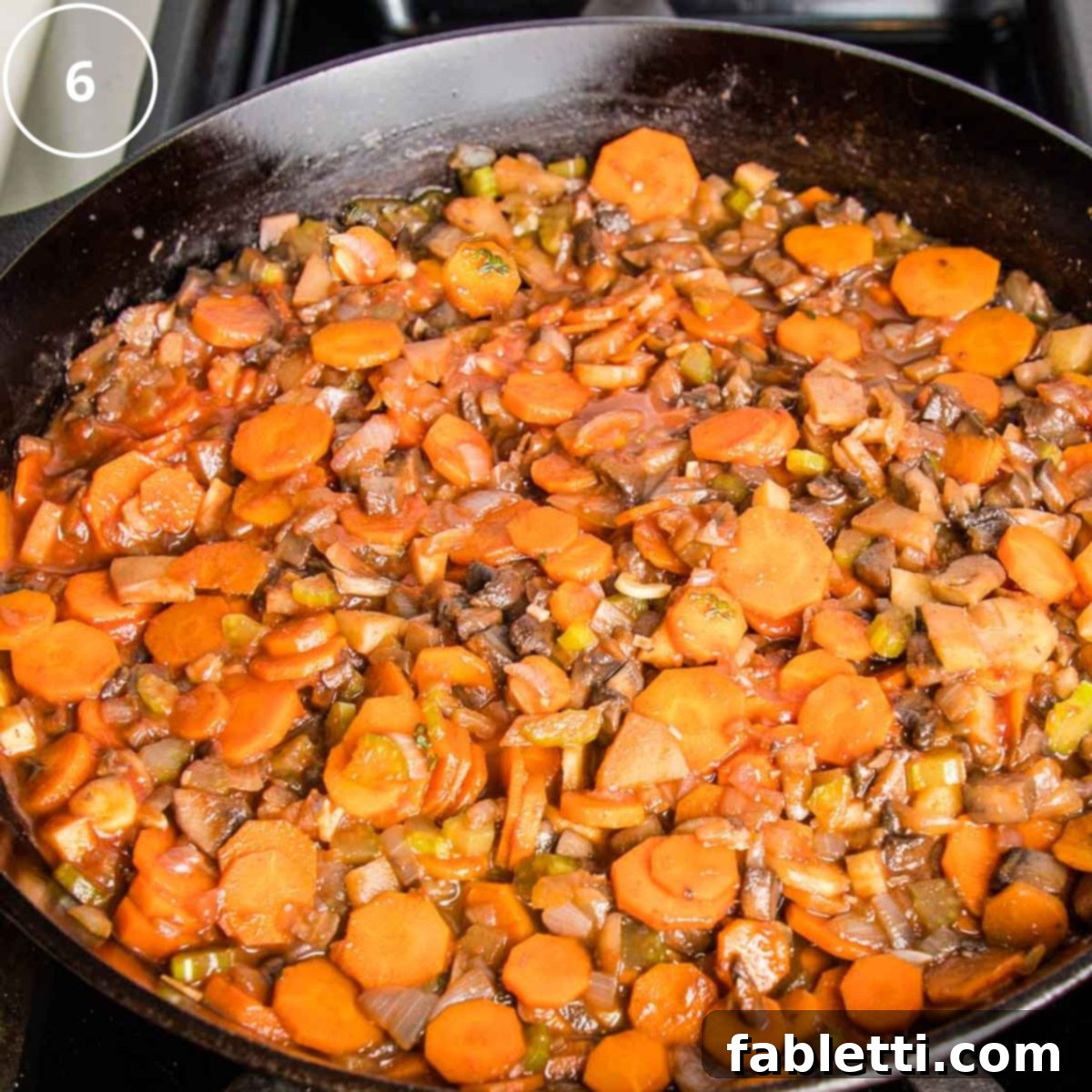 Sun-Kissed Vegan Shepherd's Pie 16 Cast iron skillet filled with vegetable filling for shepherd's pie.