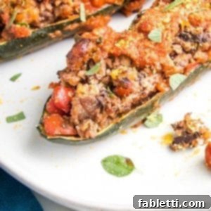 Satisfying Plant-Powered Zucchini Boats 17 A close-up of a beautifully baked zucchini boat, generously stuffed with a savory plant-based filling, crowned with rich tomato sauce and baked to perfection. It offers a hearty, meat-like experience without any meat.