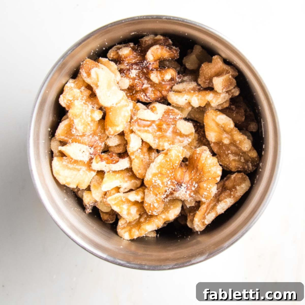 Satisfying Plant-Powered Zucchini Boats 6 Whole walnuts resting in the bowl of a spice grinder, poised to be processed for the savory filling.