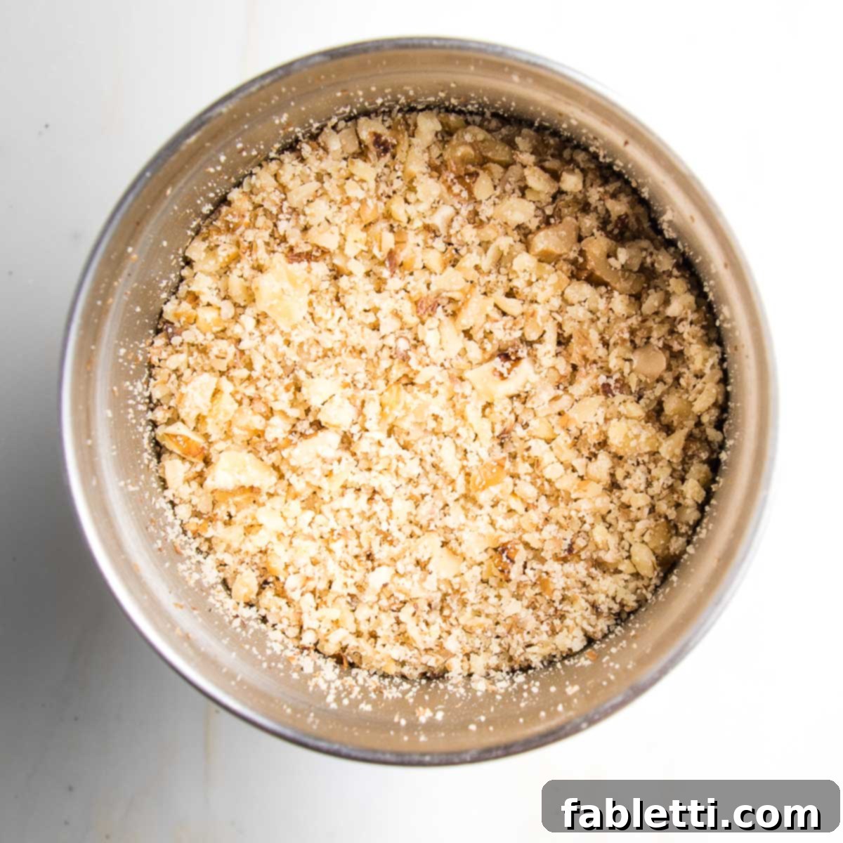 Satisfying Plant-Powered Zucchini Boats 7 Finely ground walnuts, now a crumbly mixture, resting within the bowl of a spice grinder, perfectly textured for the rich plant-based filling.