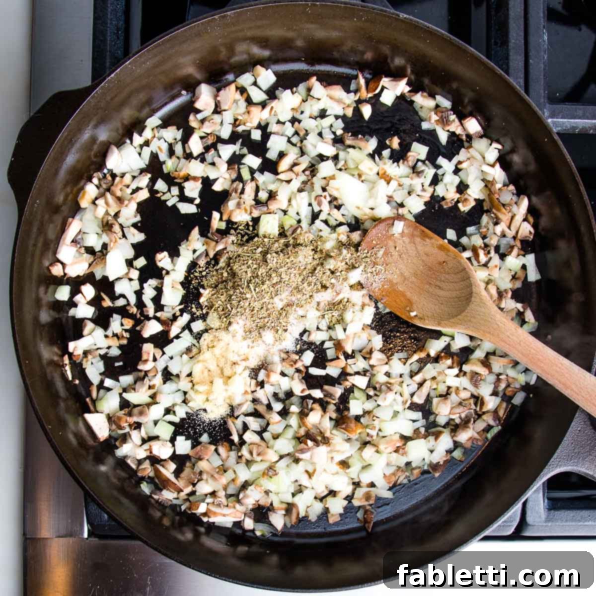 Satisfying Plant-Powered Zucchini Boats 8 A cast iron skillet, heated and ready, contains a vibrant medley of sautéing onions, mushrooms, and a flavorful blend of spices, gently cooking to form the base of the savory filling.