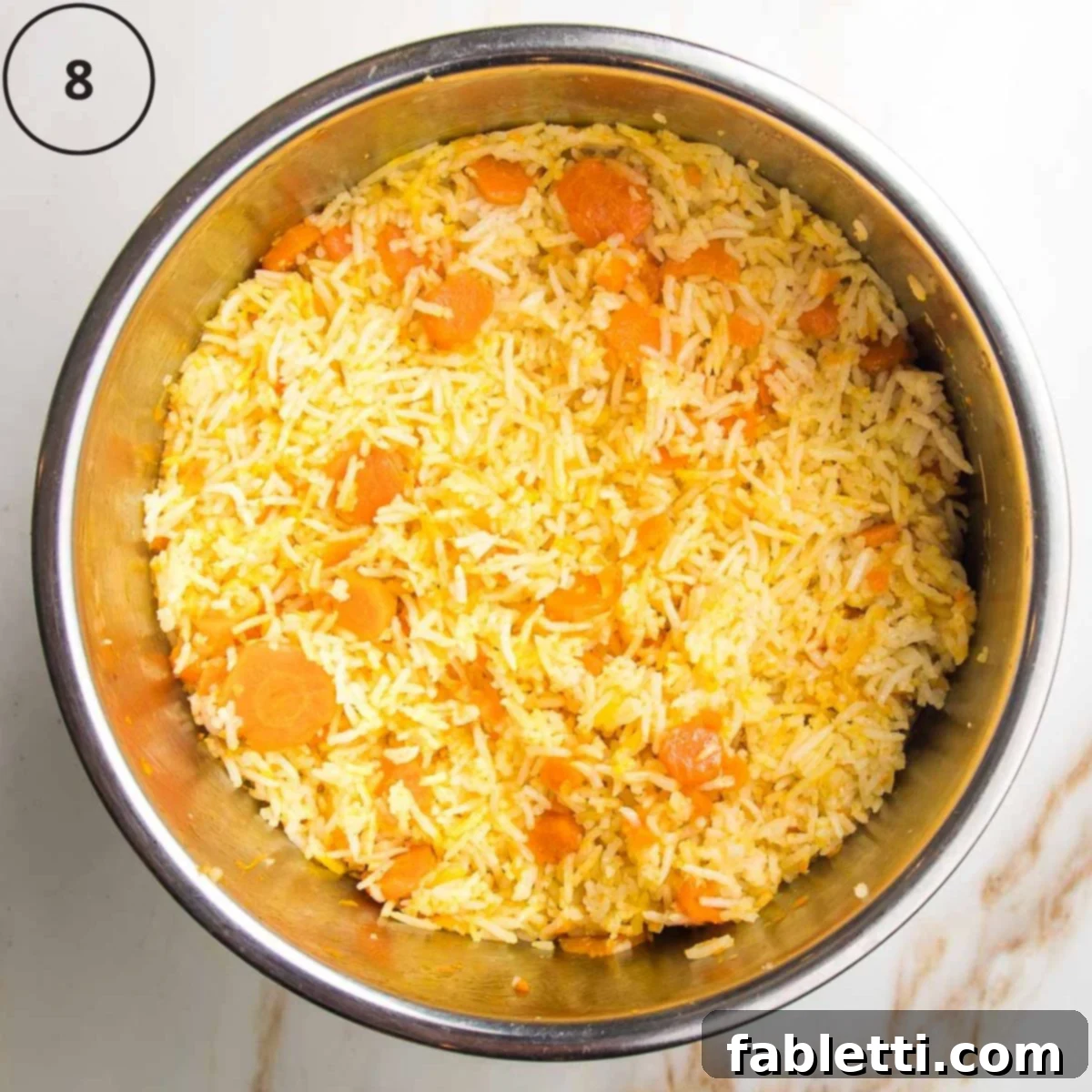 Instant pot insert with cooked rice, carrots and spices.