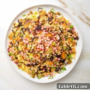 Jeweled rice with colorful pomegranate, caramelized onions, carrots, nuts and scallions.