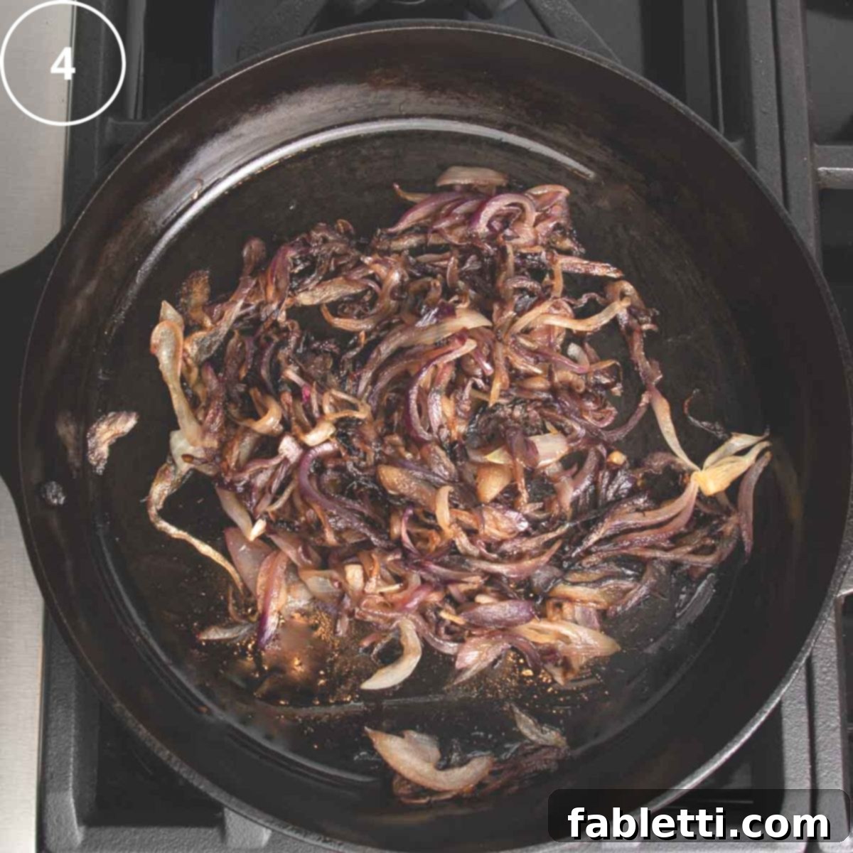 Onions, that have been caramelized, in a cast iron skillet.