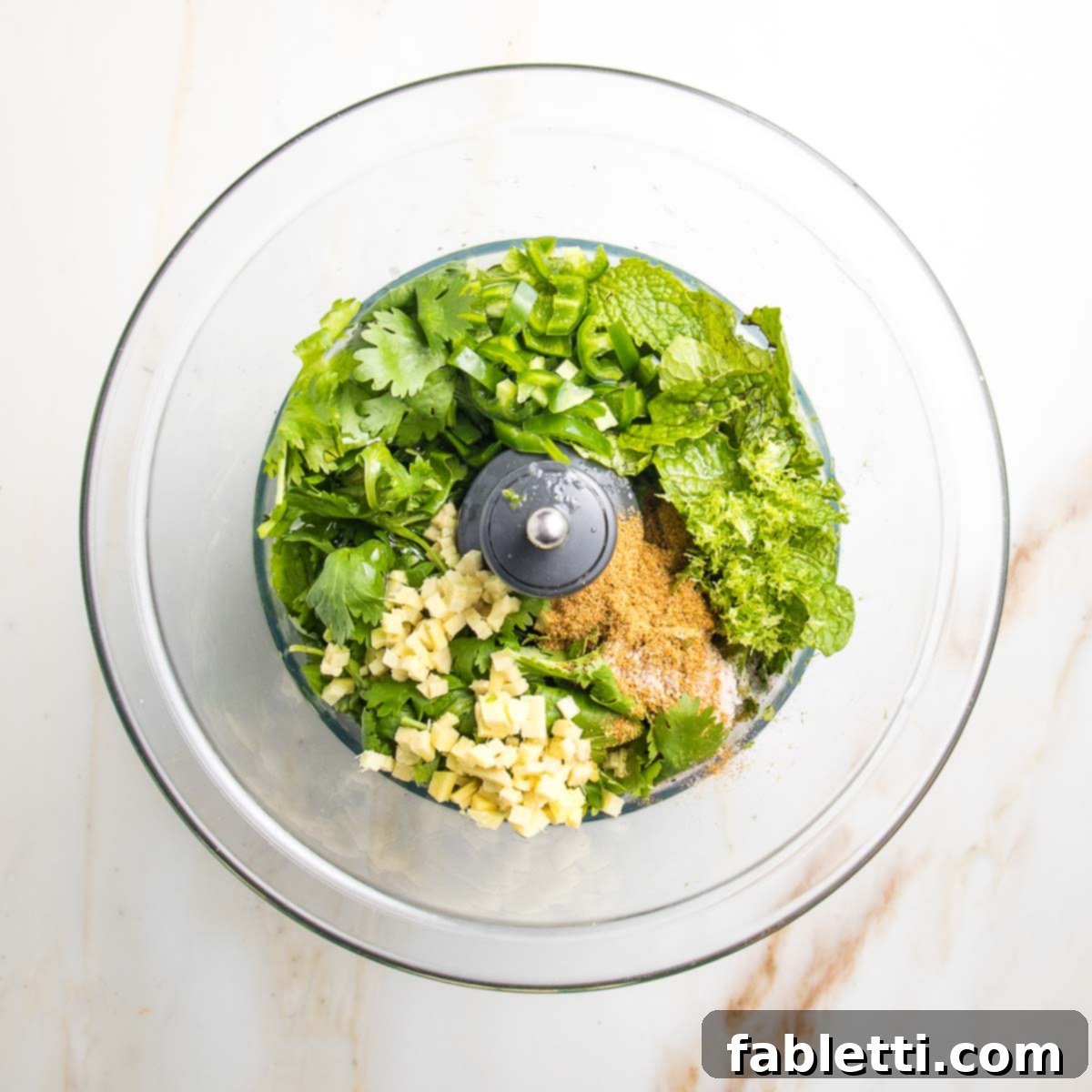 Crispy Baked Samosas with Zesty Cilantro Chutney 16 Food processor bowl with fresh cilantro and mint, minced ginger, jalapeno, honey, spices.