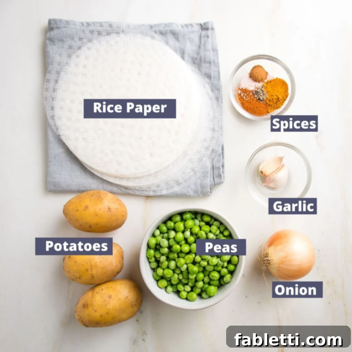 Crispy Baked Samosas with Zesty Cilantro Chutney 3 Labeled ingredients for baked samosa recipe: Rice paper wrappers, spices, garlic, onion, green peas and yukon gold potatoes