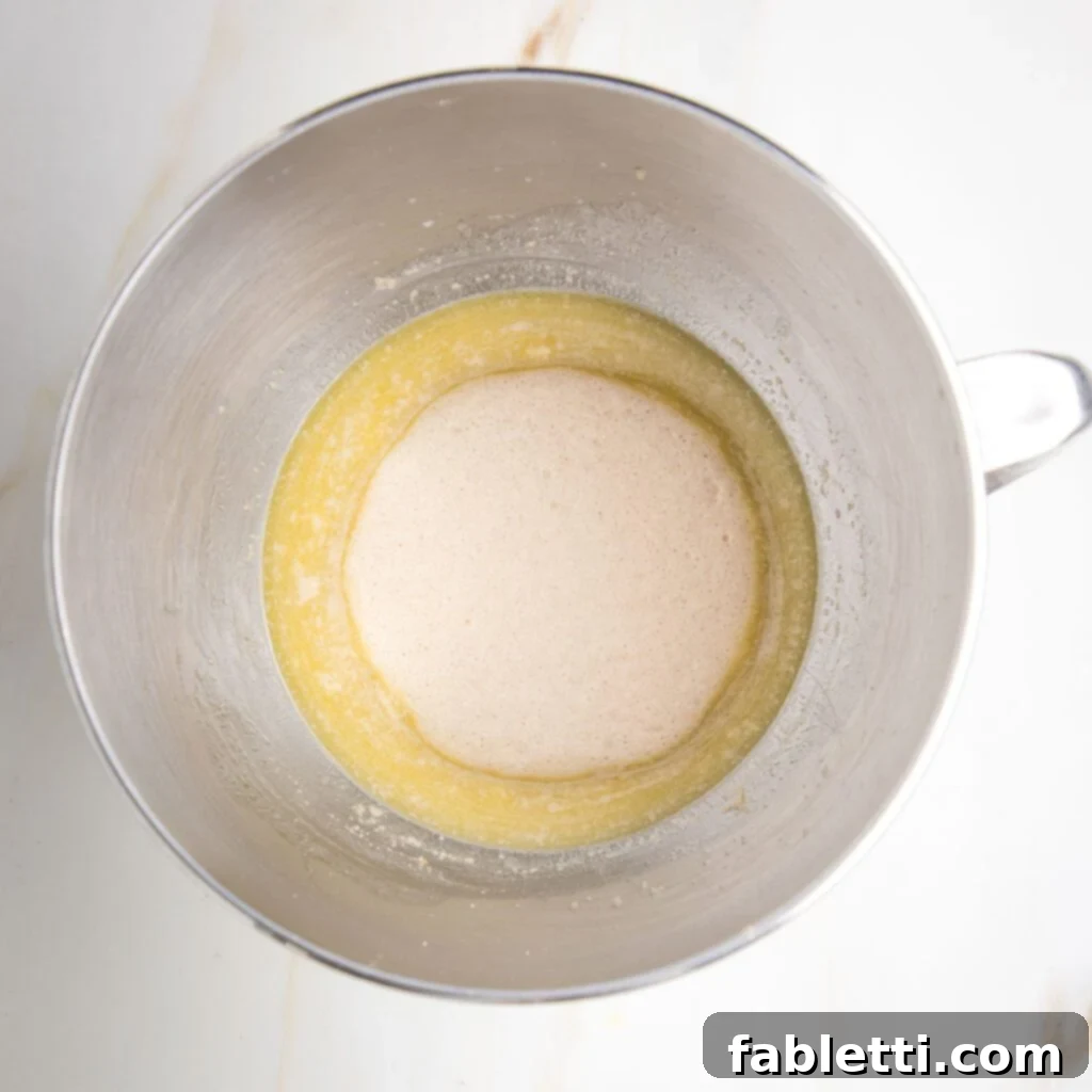 Fluffy Vegan Dinner Rolls 7 bubbling, foamy yeast that has proofed with some yellow liquid underneath