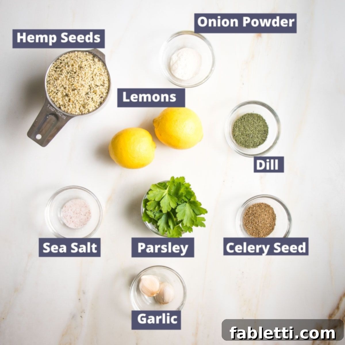 Deliciously Healthy Homemade Ranch 4 A beautifully arranged selection of fresh ingredients for healthy ranch dressing, including bright green parsley, aromatic dill, garlic cloves, zesty lemons, and creamy hemp seeds, ready for blending.