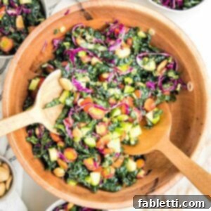 Rustic Tuscan Chopped Kale Medley 14 wooden salad bowl filled with colorful chopped salad: tuscan kale, purple carrots, red peppers, purple cabbage, cucumbers and marcona almonds