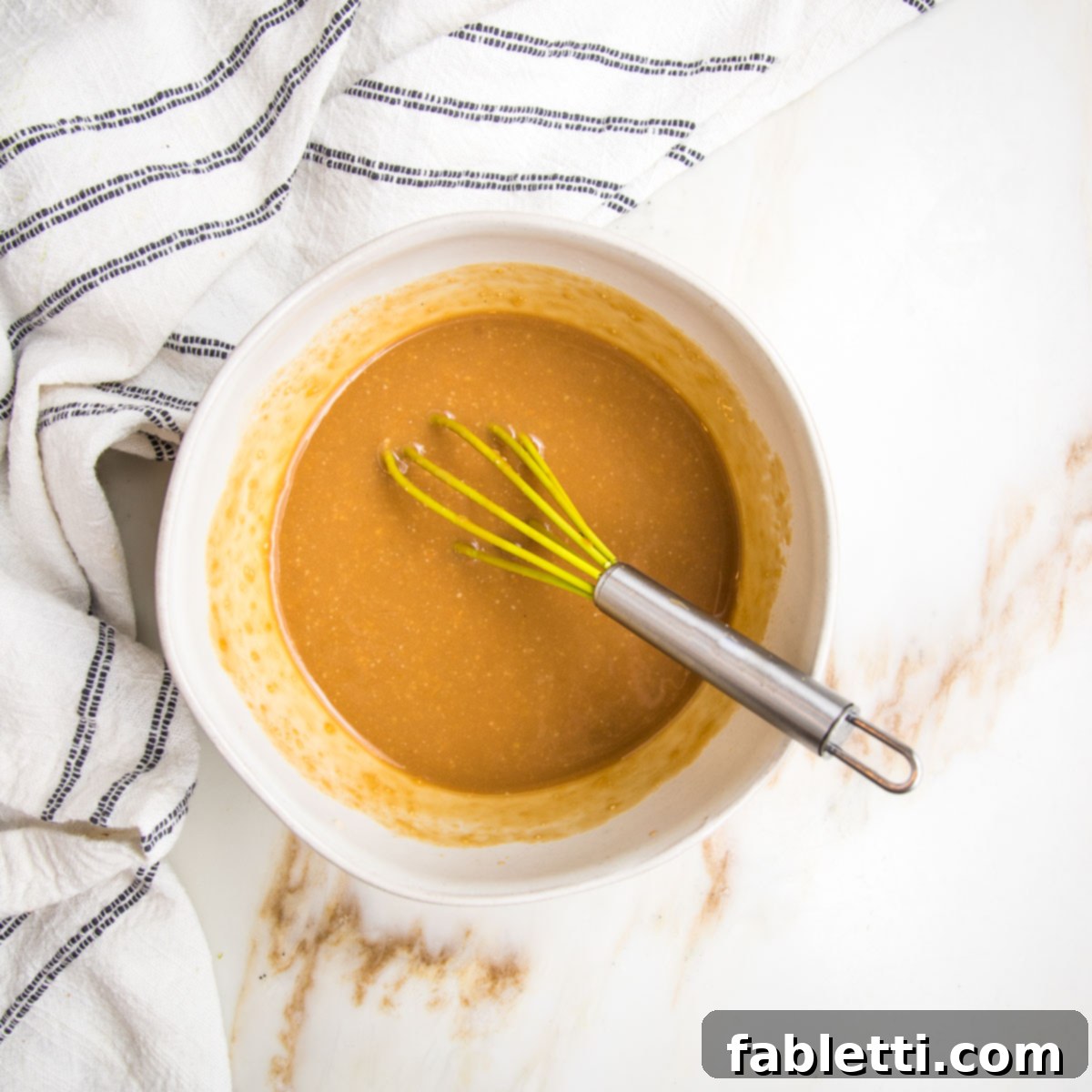 Rustic Tuscan Chopped Kale Medley 9 Miso dressing in a small bowl with a whisk.