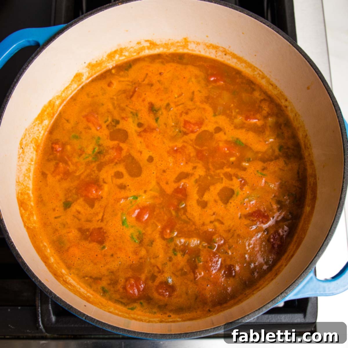 Hearty Vegan Taco Soup with Crispy Tortilla Strips 14 taco soup simmering on the stove in a dutch oven.