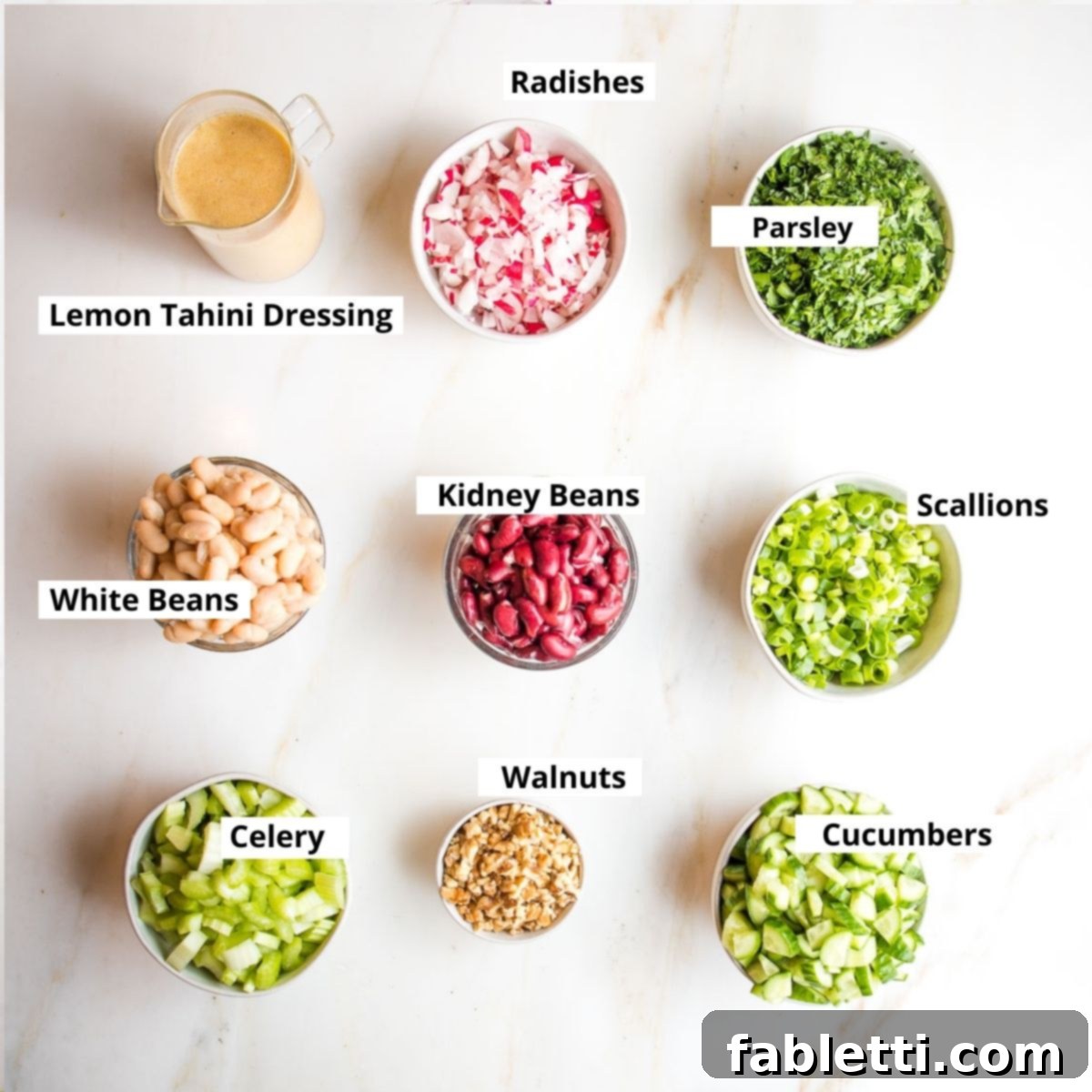 Zesty Kidney Bean Salad 3 Labeled ingredients: tahini dressing, radishes, parsley, white beans, kidney beans, scallions, celery, walnuts and cucumbers.