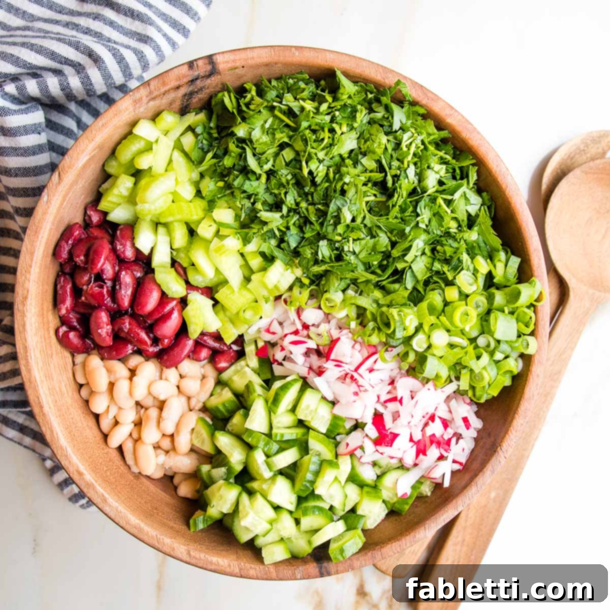 Zesty Kidney Bean Salad 5 Large wooden bowl with colorful sections of beans and chopped veggies.