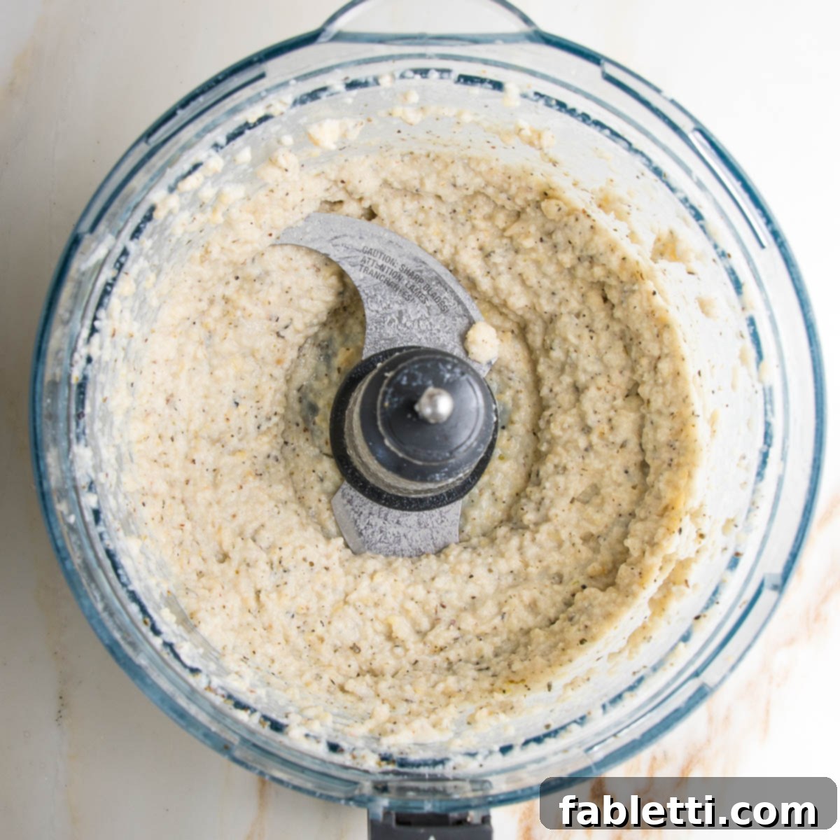vegan ricotta in the bowl of a food processor.