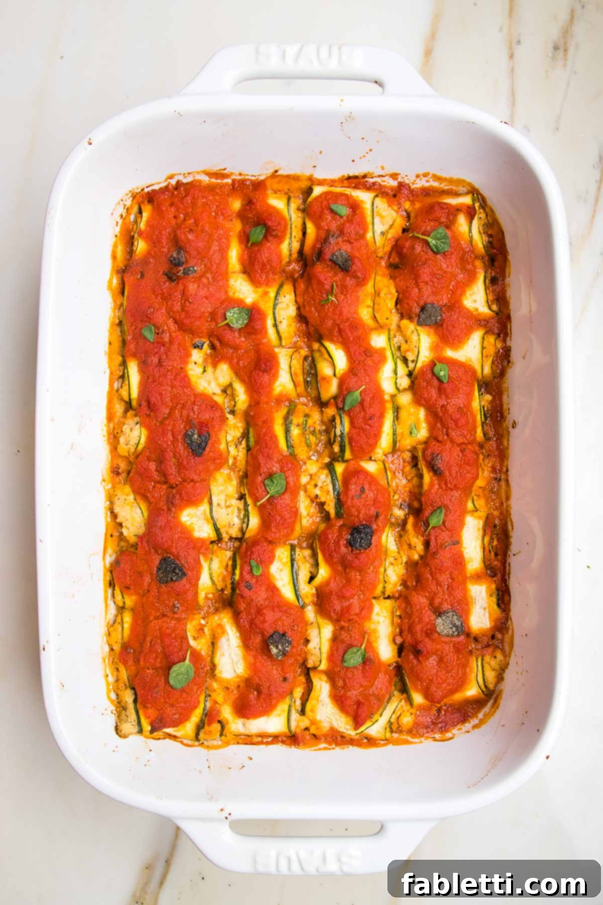 Plant-Based Zucchini Ricotta Rolls 13 Baked zucchini lasagna roll ups ready to serve.