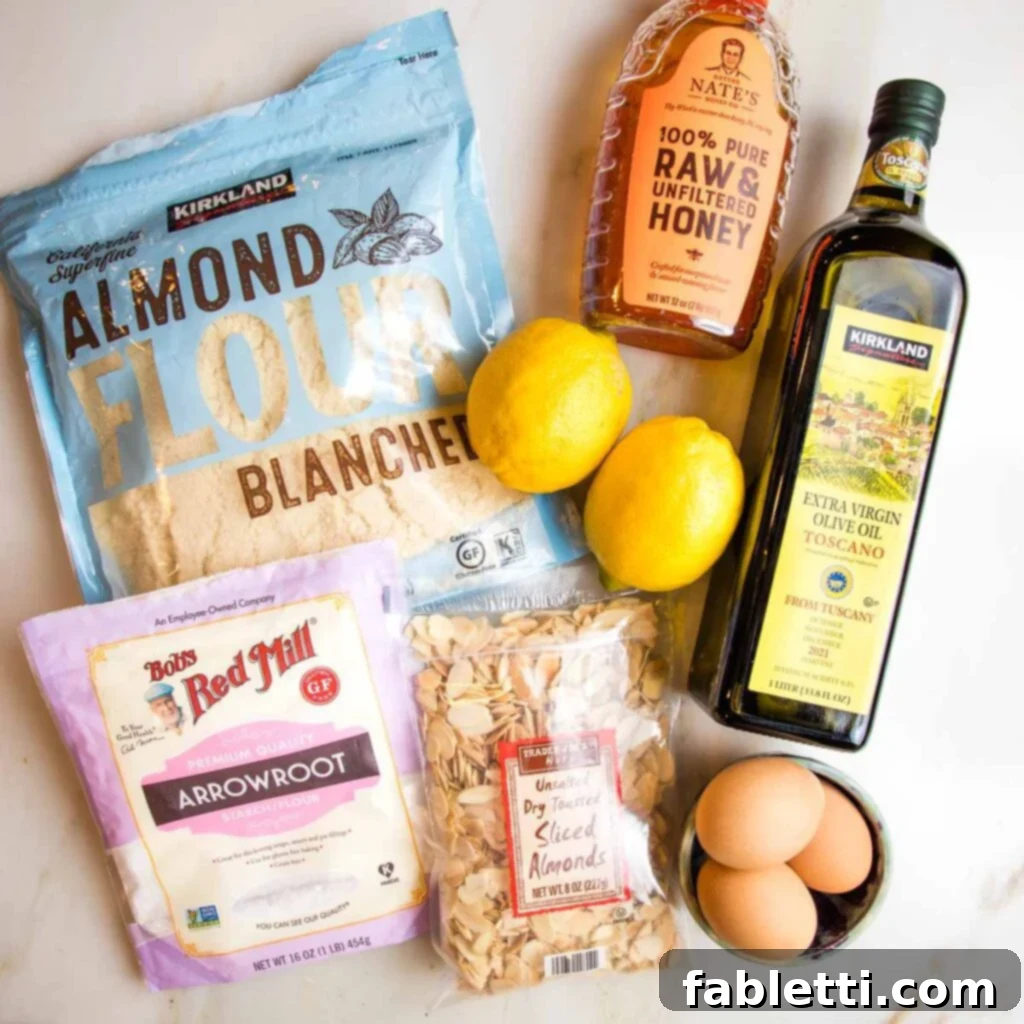 Ingredients for gluten-free lemon cake: almond flour, arrowroot powder, sliced almonds, lemons, honey, olive oil and eggs.