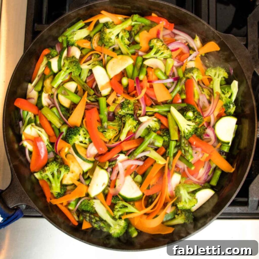 Vibrant Vegan Primavera Pasta 12 All the vegetables – broccoli, asparagus, red onion, zucchini, and red pepper – beautifully sautéing in the skillet.