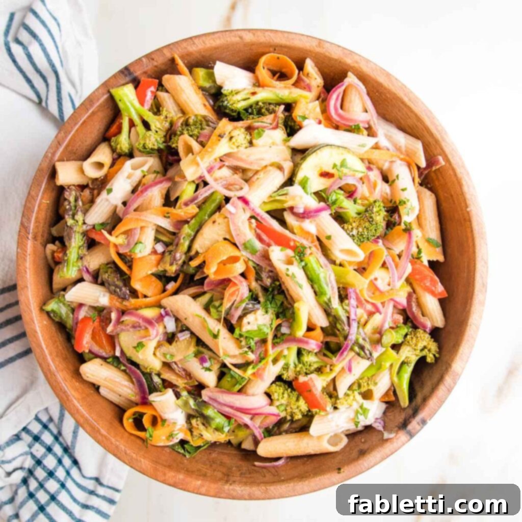 Vibrant Vegan Primavera Pasta 17 A freshly plated serving of vegan pasta primavera, garnished with herbs and a lemon slice, ready to be enjoyed.