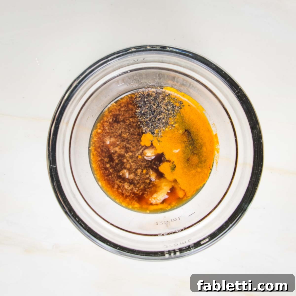 Grilled Tofu Satay with Creamy Peanut Sauce 6 Tofu marinade ingredients in a small bowl: tamari, lime juice, maple syrup, garlic, ginger, turmeric and black pepper.