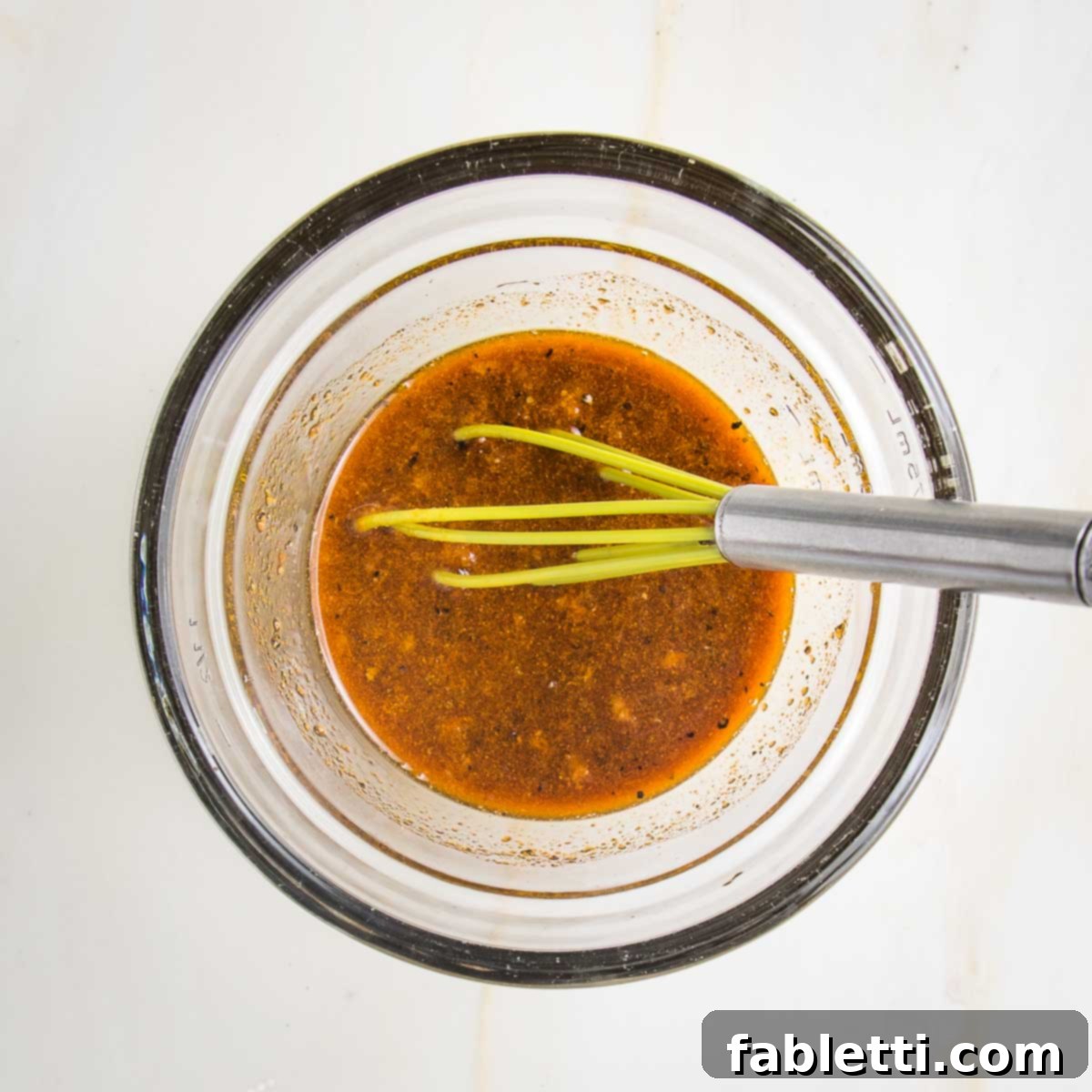 Grilled Tofu Satay with Creamy Peanut Sauce 7 Tofu marinade ingredients whisked together in a small bowl. It's brown liquid with flecks of pepper, chunks of garlic and ginger and light yellowish color from the turmeric.