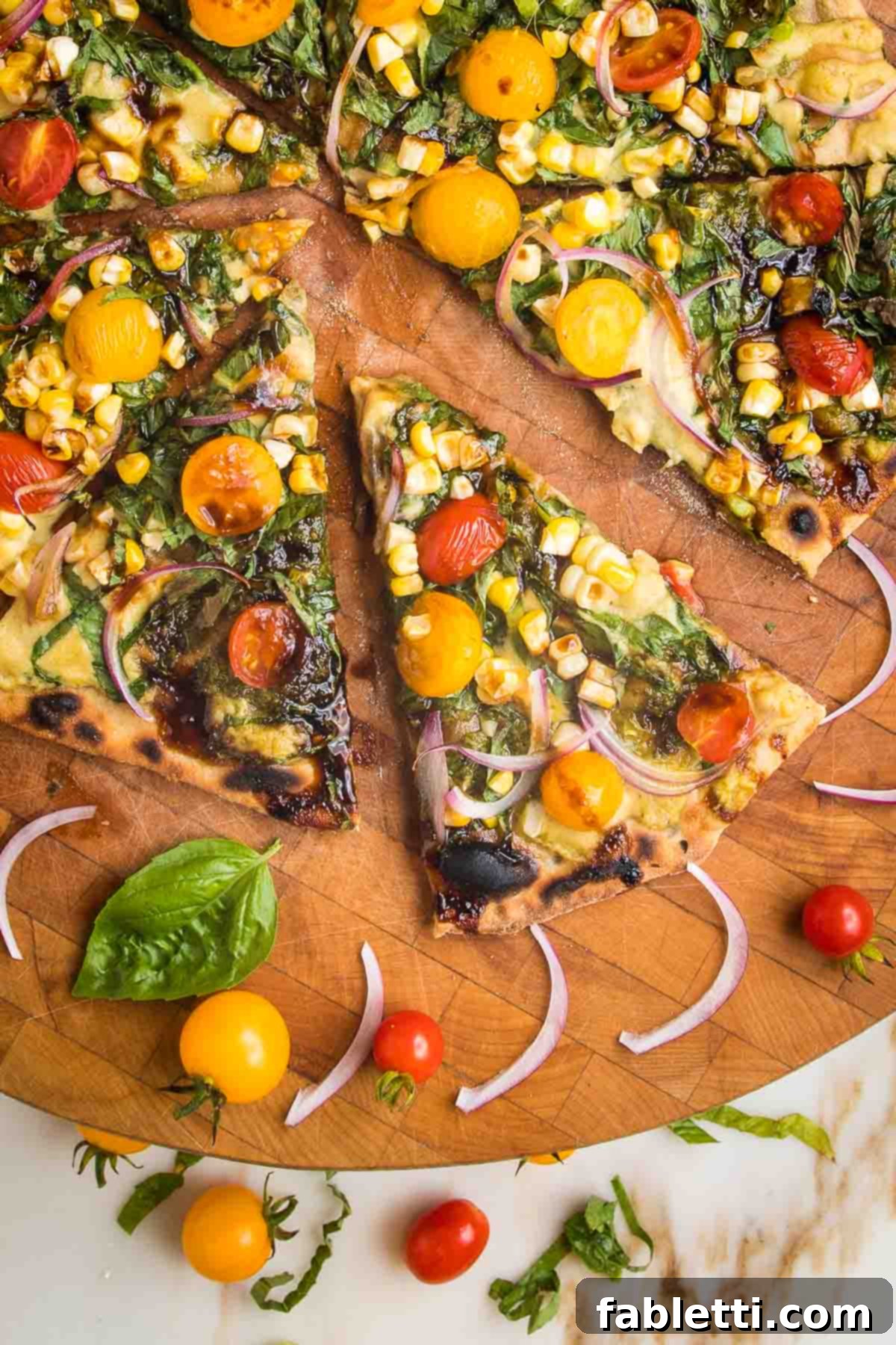 Effortless Yeast-Free Flatbread Pizza 2 No yeast flatbread recipe, slathered with pesto and hummus and topped with fresh tomatoes, corn and onions, showcasing a vibrant, fresh meal.