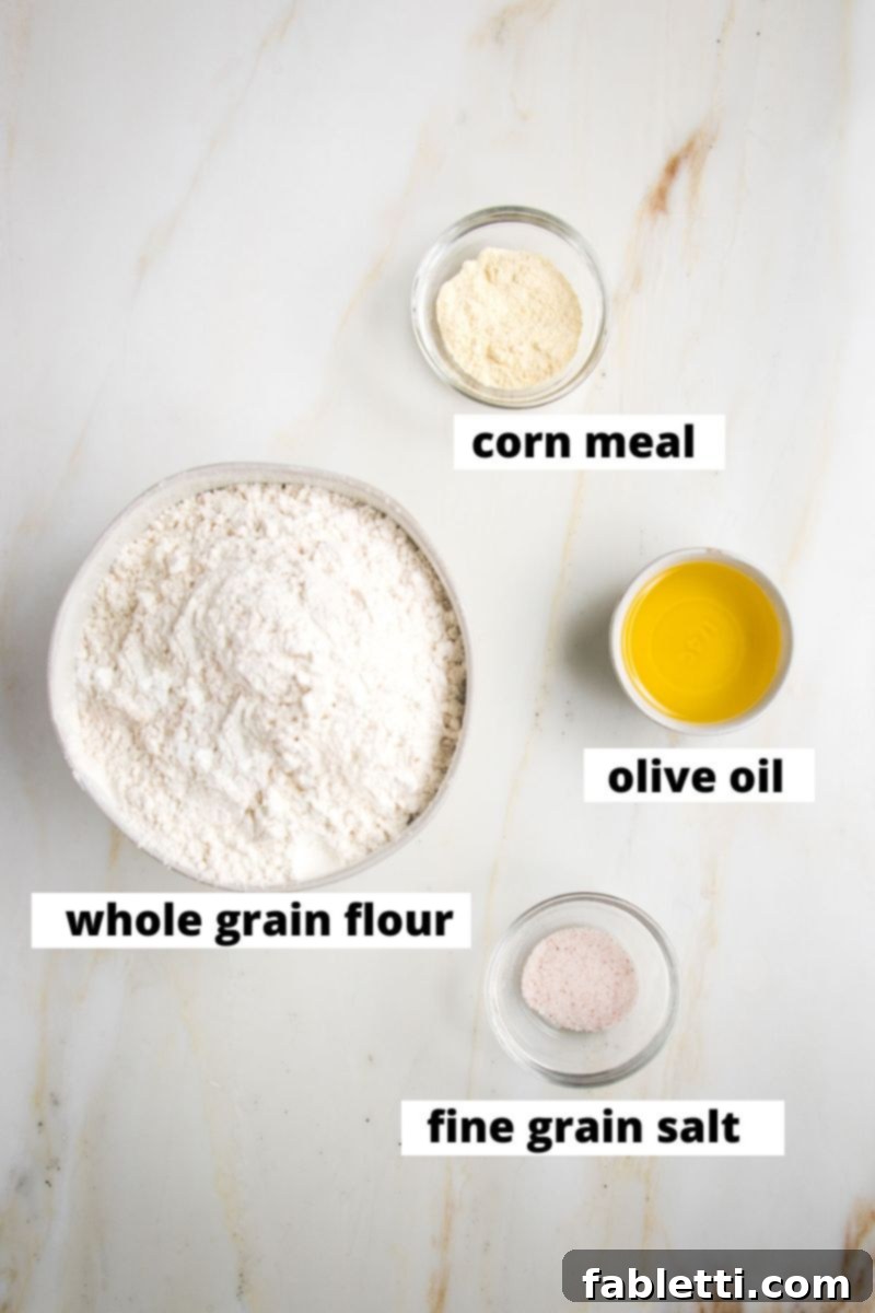 Effortless Yeast-Free Flatbread Pizza 3 Flatbread dough ingredients labeled: whole grain flour, corn meal, olive oil, fine grain sea salt, clearly laid out for easy identification.