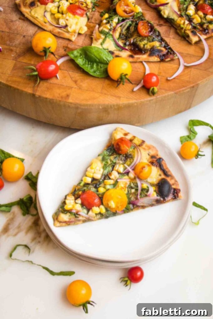 Effortless Yeast-Free Flatbread Pizza 4 Slice of flatbread, topped with fresh tomatoes, corn, onions and basil on a white plate, with remaining pizza slices on a wooden cutting board, ready to serve.