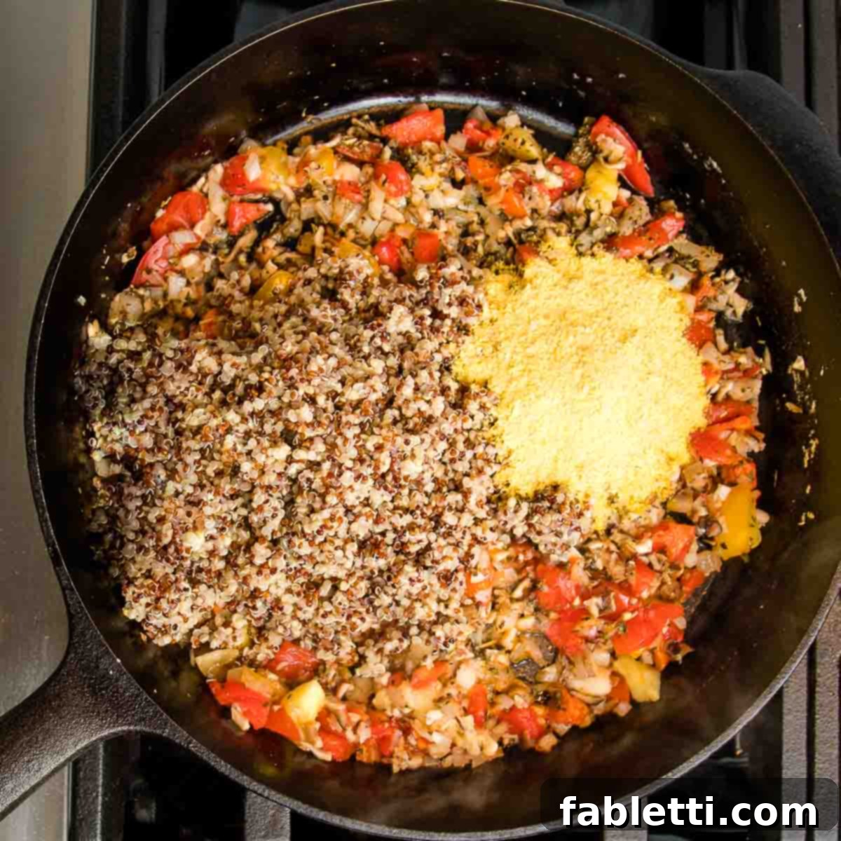 Plant-Powered Stuffed Tomatoes 11 Cast iron skillet with sautéed vegetables, topped with cooked quinoa and nutritional yeast.