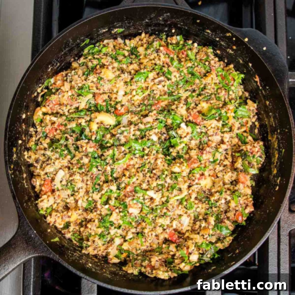 Plant-Powered Stuffed Tomatoes 13 Cast iron skillet with a perfectly mixed stuffing of sautéed veggies, quinoa, tomatoes, and chopped greens.
