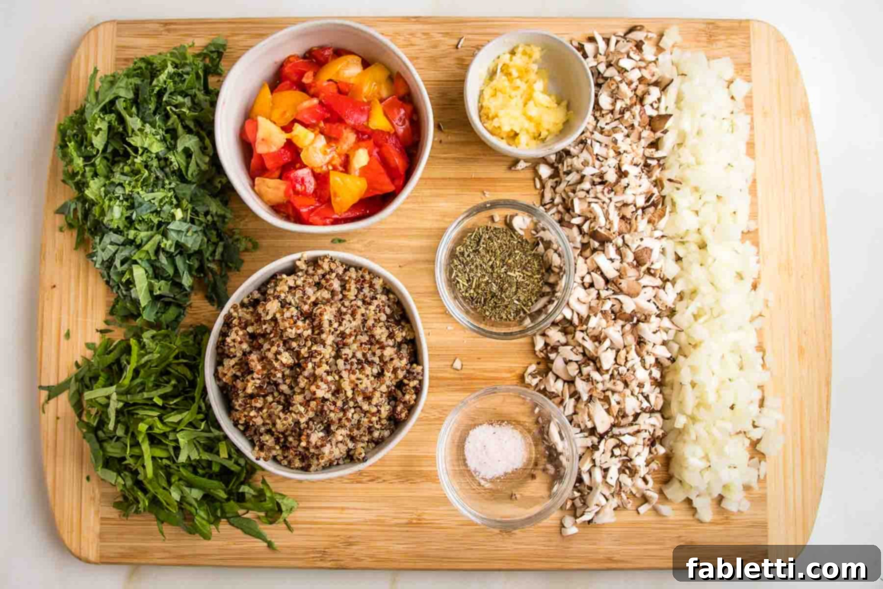 Plant-Powered Stuffed Tomatoes 8 Arrangement of chopped kale, basil, mushrooms, and onions alongside bowls filled with cooked quinoa, diced tomato pulp, grated garlic, salt, Italian seasoning, and nutritional yeast.