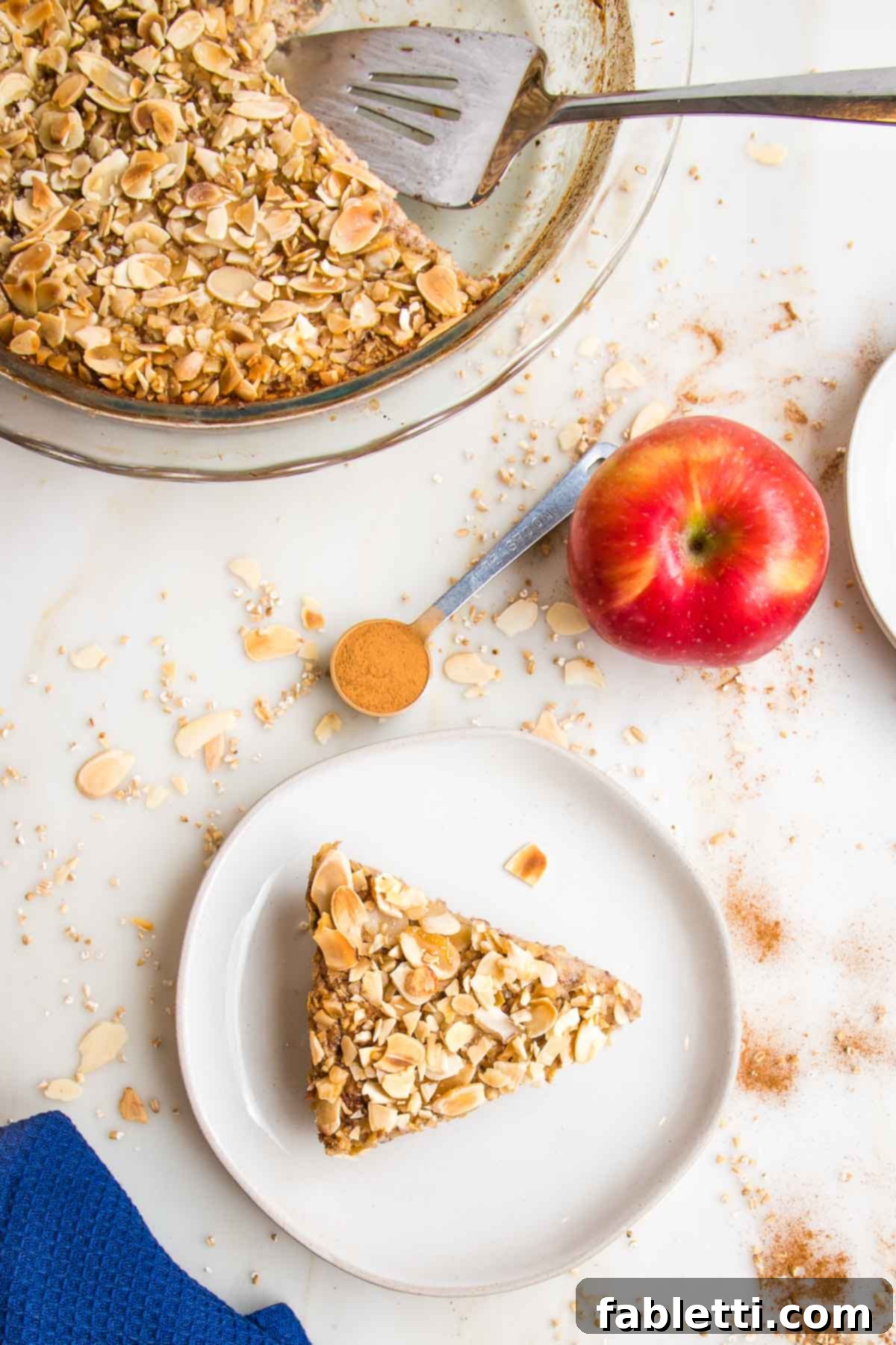 Hearty Baked Steel-Cut Oats 2 Pie plate of baked steel cut oats with one slice on a plate.
