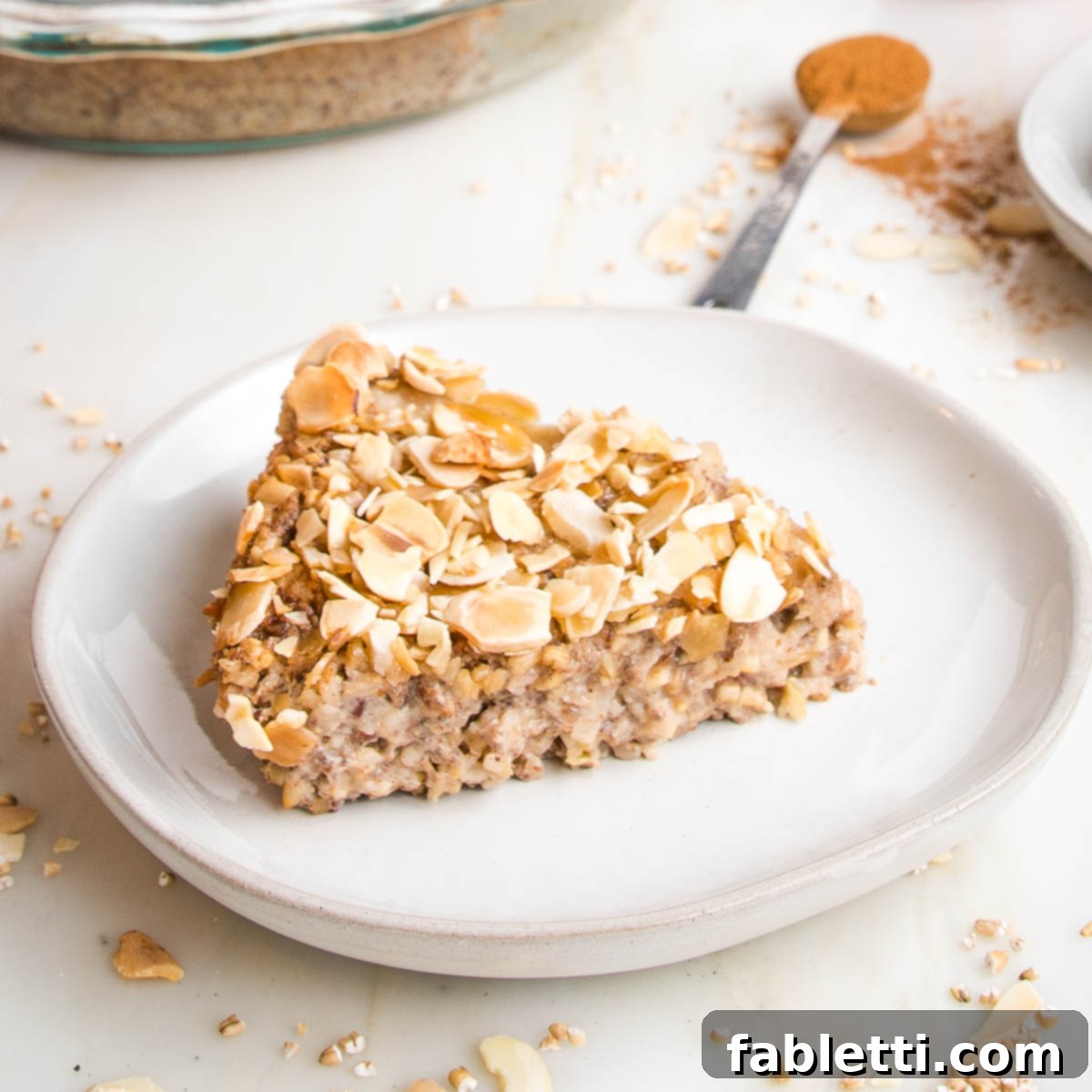 Hearty Baked Steel-Cut Oats 3 Slice of steel cut oats with sliced almonds on top.