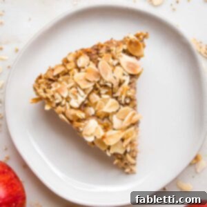 Hearty Baked Steel-Cut Oats 16 Pie slice of apple baked steel cut oatmeal on a white rimmed plate.