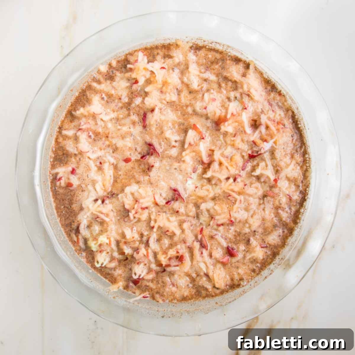 Hearty Baked Steel-Cut Oats 10 Steel cut oats mixed with apples, spices and almond milk in a glass pie plate.