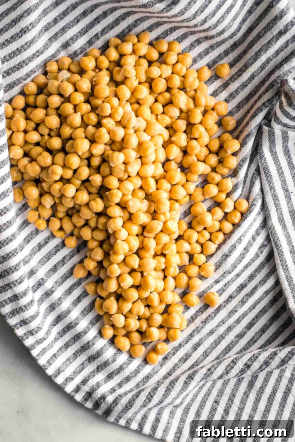 Golden Crispy Chickpea Bites 4 Canned chickpeas spread on a striped dish towel.