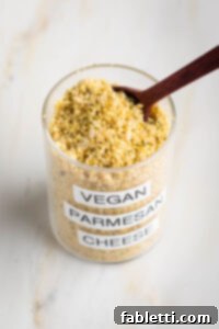 Nut-Free Plant-Based Parmesan 8 Small glass spice jar filled with vegan parmesan cheese.