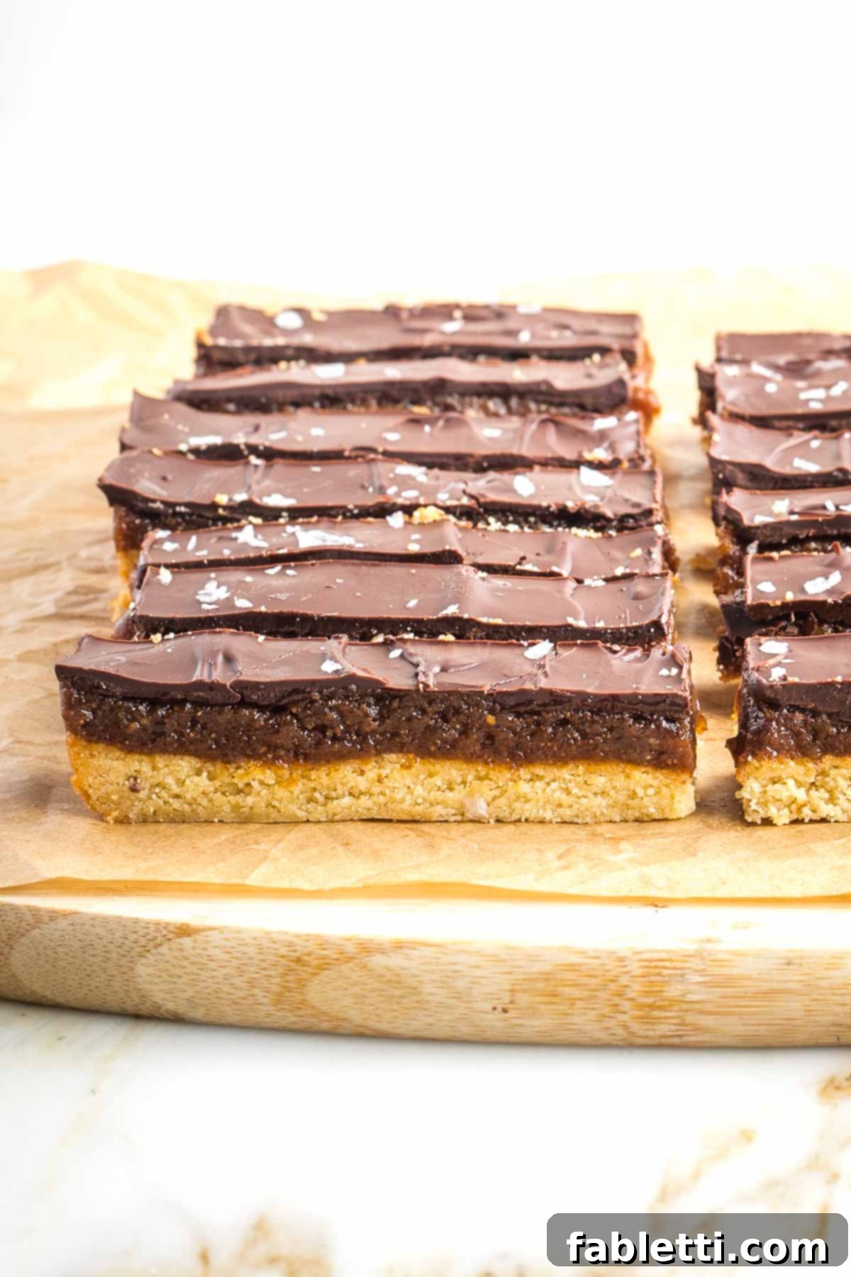 Guilt-Free Homemade Twix Bars 20 A cutting board displays the beautifully sliced homemade twix bars, perfectly portioned and ready to be enjoyed.