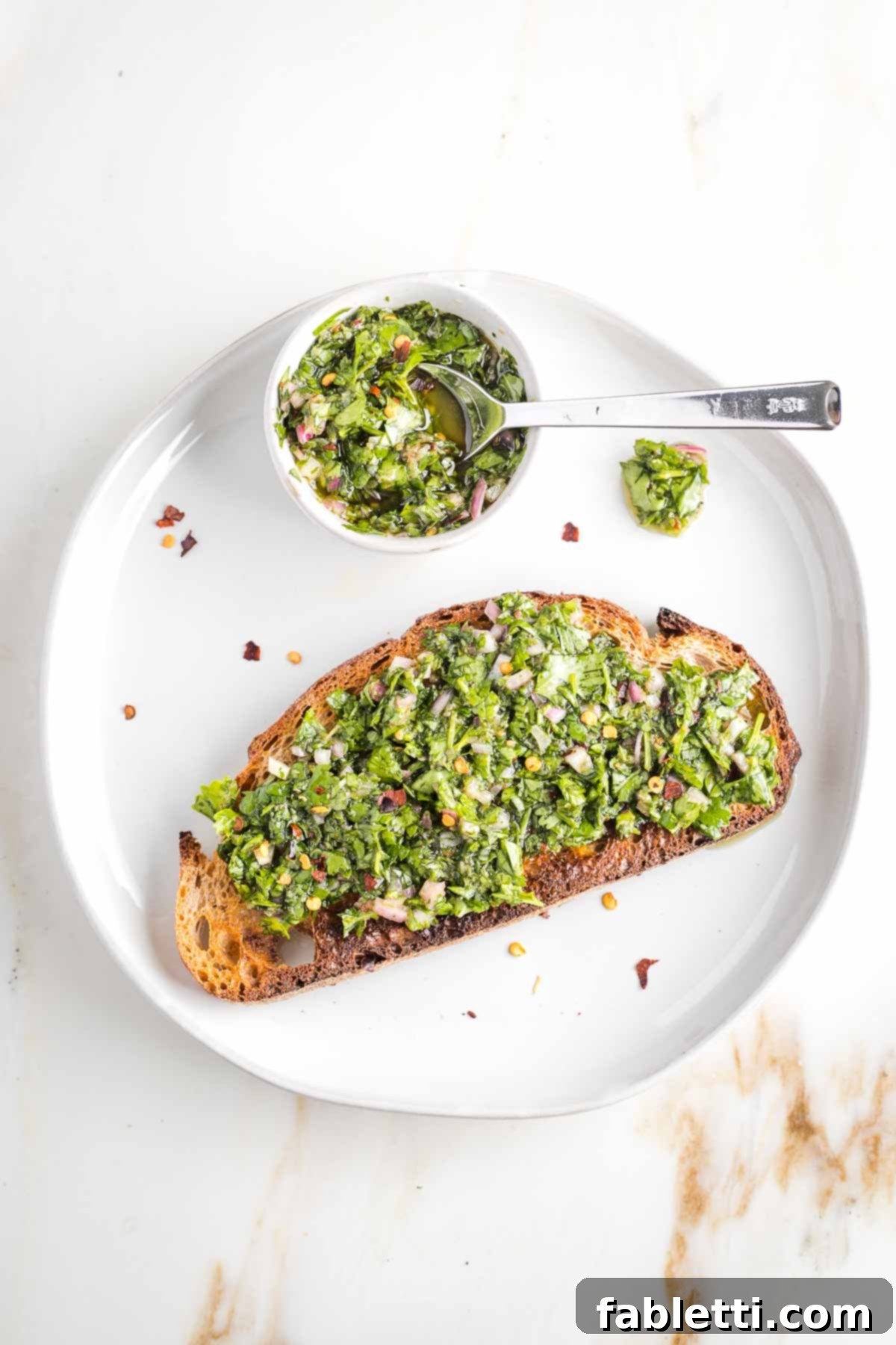 Vibrant Cilantro Chimichurri 2 Sourdough toast smothered with chimichurri sauce on a plate, highlighting the fresh green herbs and vibrant texture.