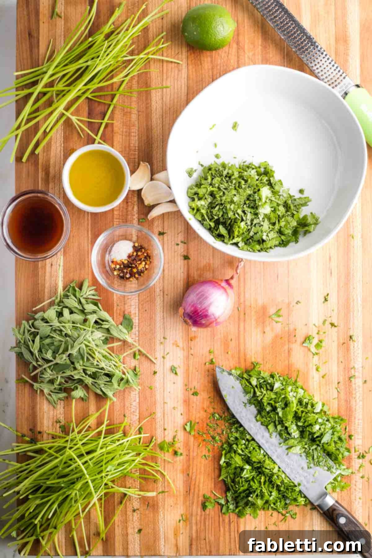Vibrant Cilantro Chimichurri 4 Cutting board with fresh cilantro, parsley, and oregano, stemmed and finely chopped, ready for mixing.