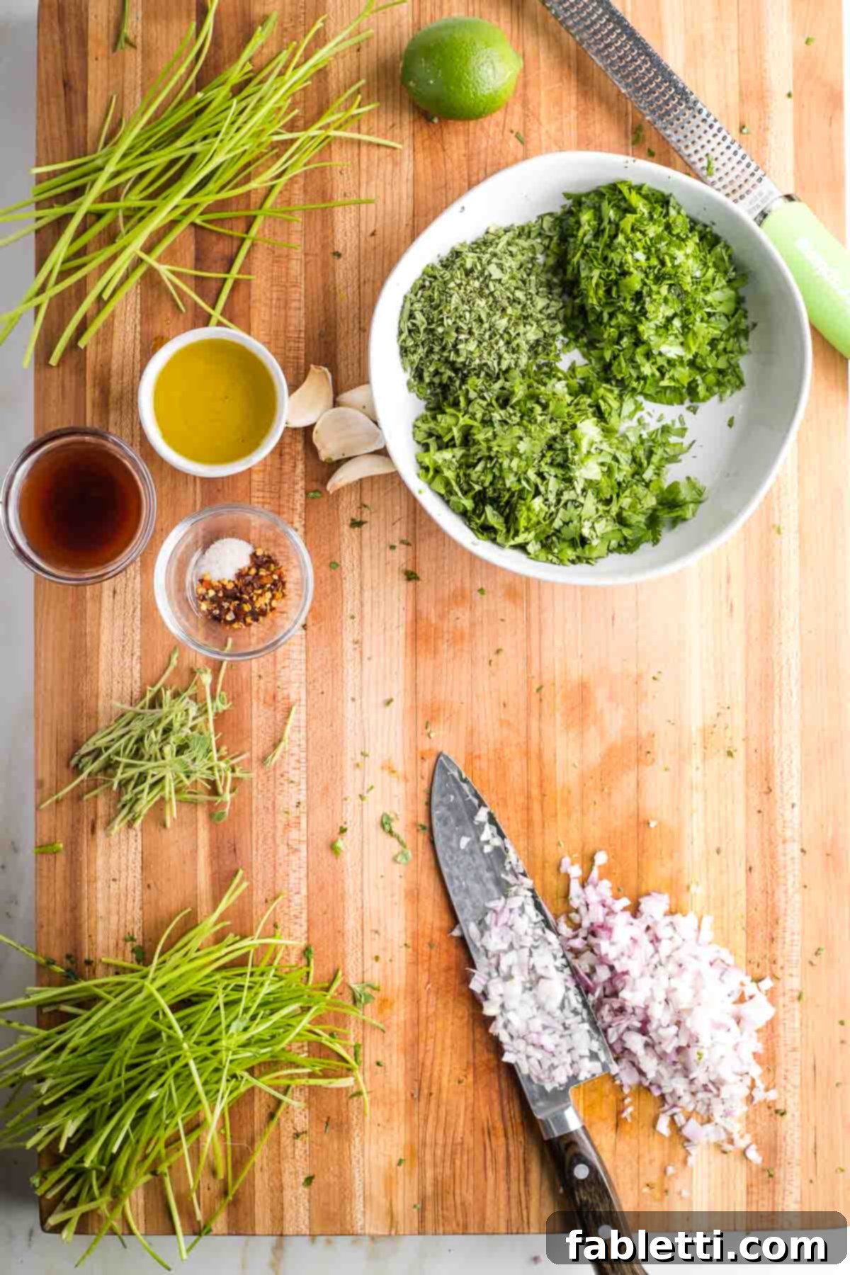 Vibrant Cilantro Chimichurri 5 Finely chopping a shallot to go in a bowl with fresh chopped herbs, adding an aromatic depth.