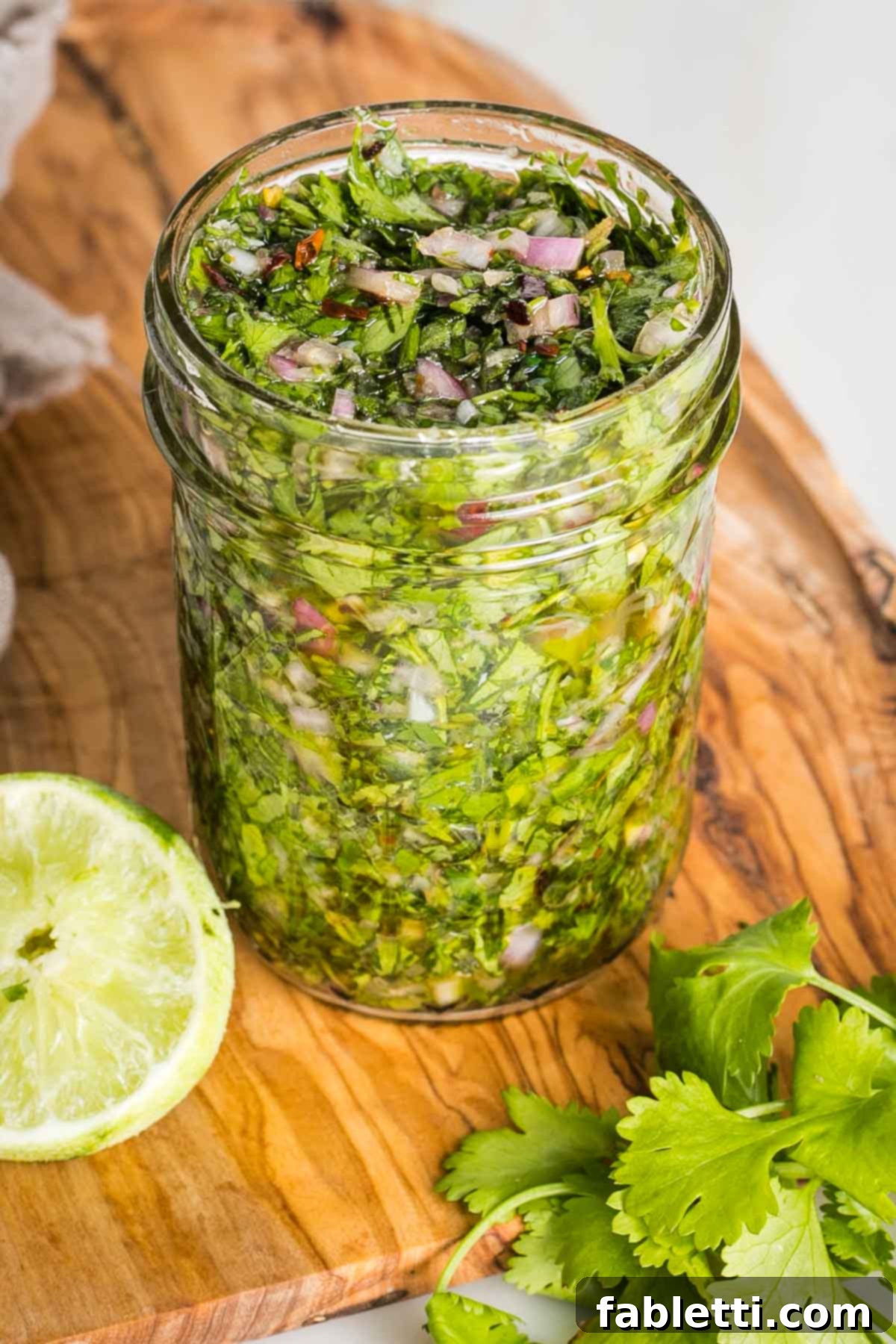 Vibrant Cilantro Chimichurri 9 Small mason jar filled with bright green chimichurri sauce, showcasing its rich color and chunky texture.