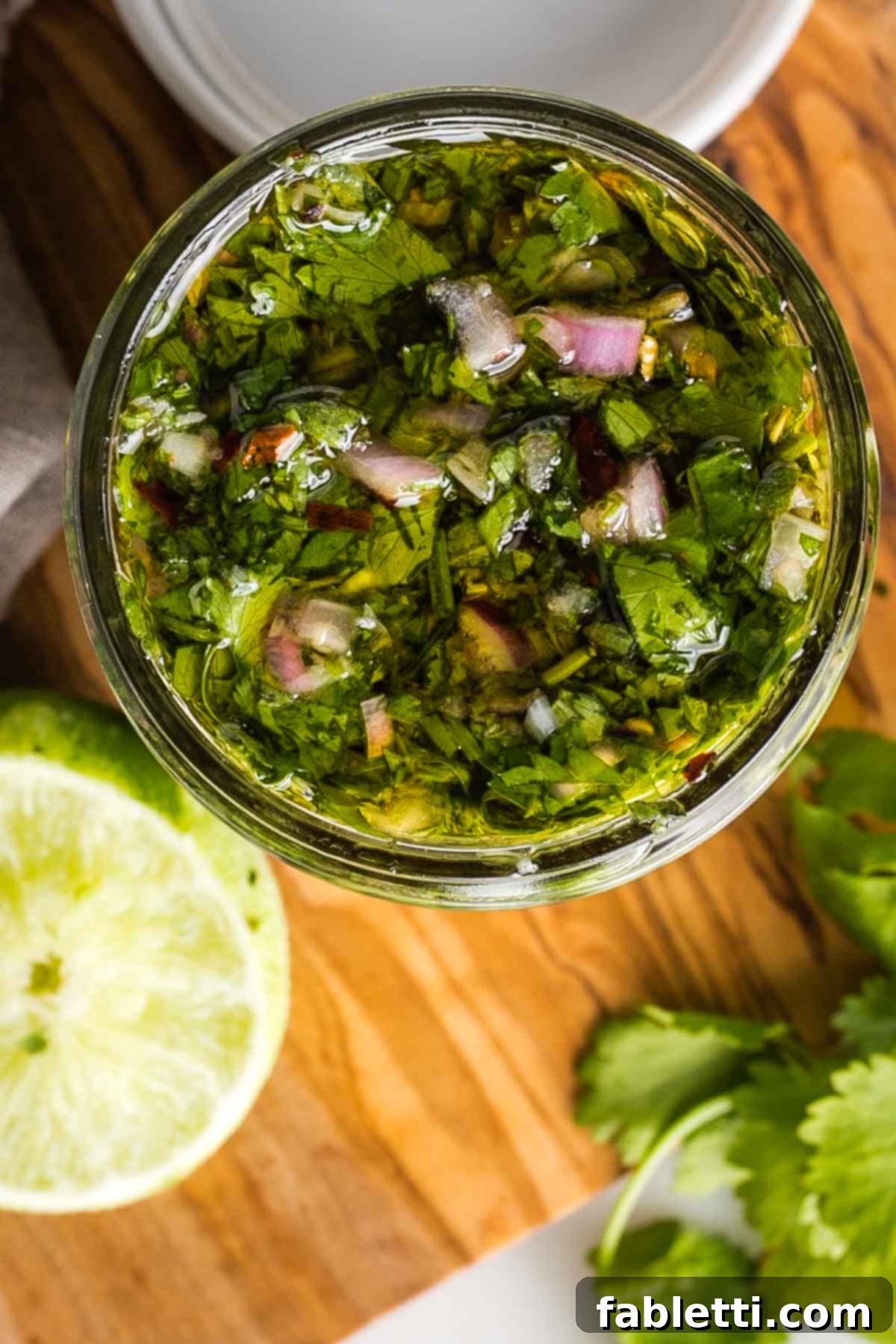 Vibrant Cilantro Chimichurri 10 A thin layer of olive oil covering chimichurri sauce in a mason jar, protecting its fresh color.