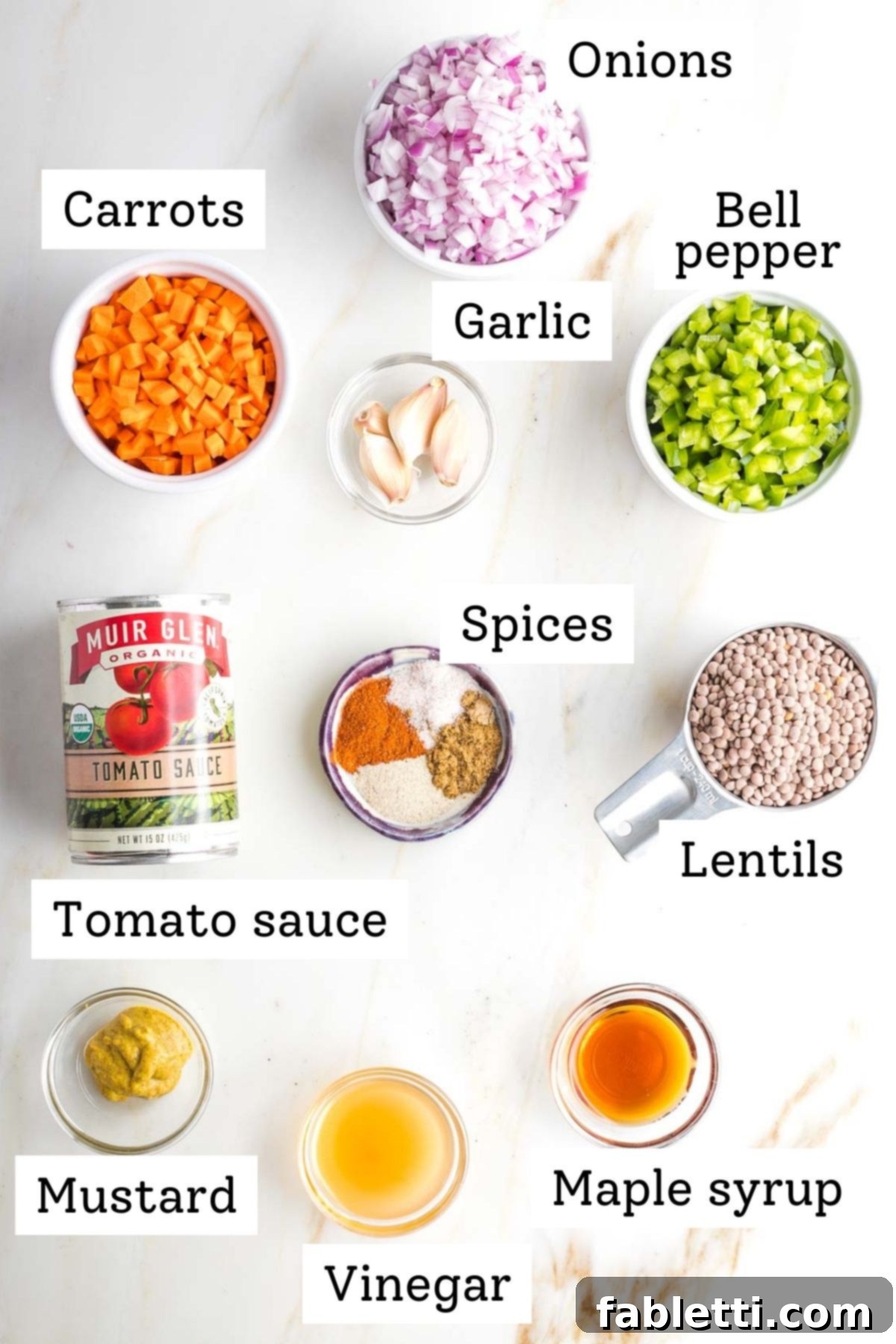 Vegan sloppy joe labeled ingredients: onion, carrot, bell pepper, garlic, spices, tomato sauce, mustard, vinegar, lentils and maple syrup.