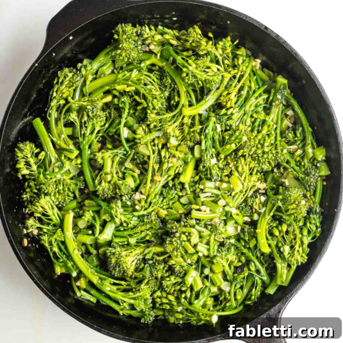 Cast iron skillet with sauteed broccolini, garlic and crushed red pepper.
