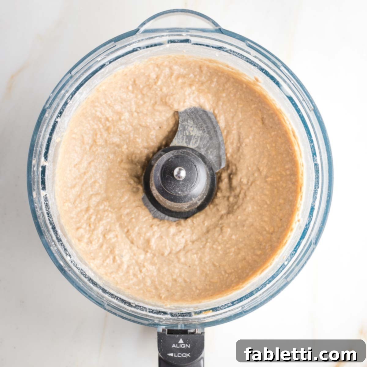 Bean-Powered Vegan Blondies 8 Light colored cookie batter in the bowl of a food processor.