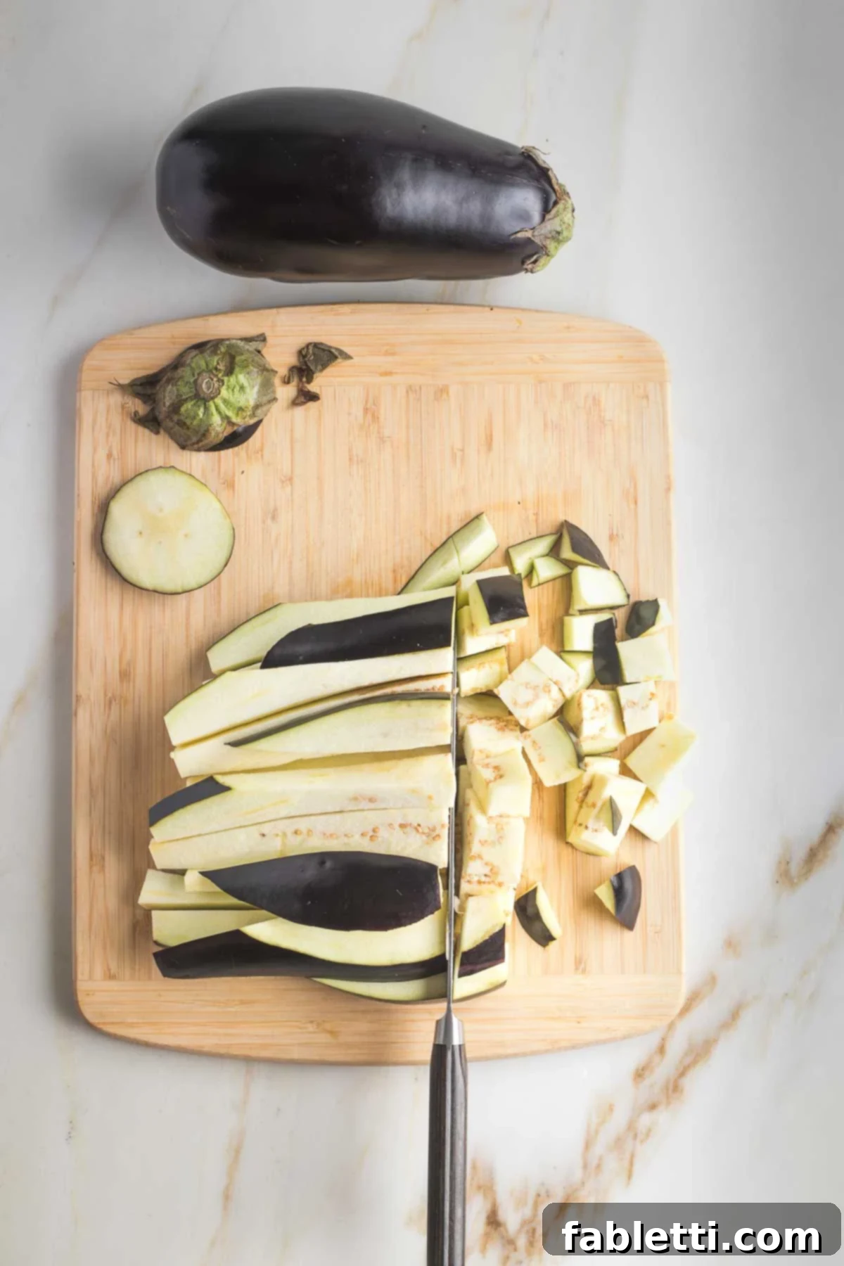Savory Sautéed Eggplant Salad 6 Eggplant strips being cut across to form ½-inch cubes.